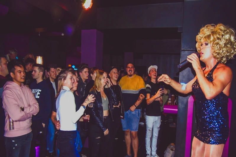 a drag queen with a mic addressing the dancefloor at OMG Bristol Bar