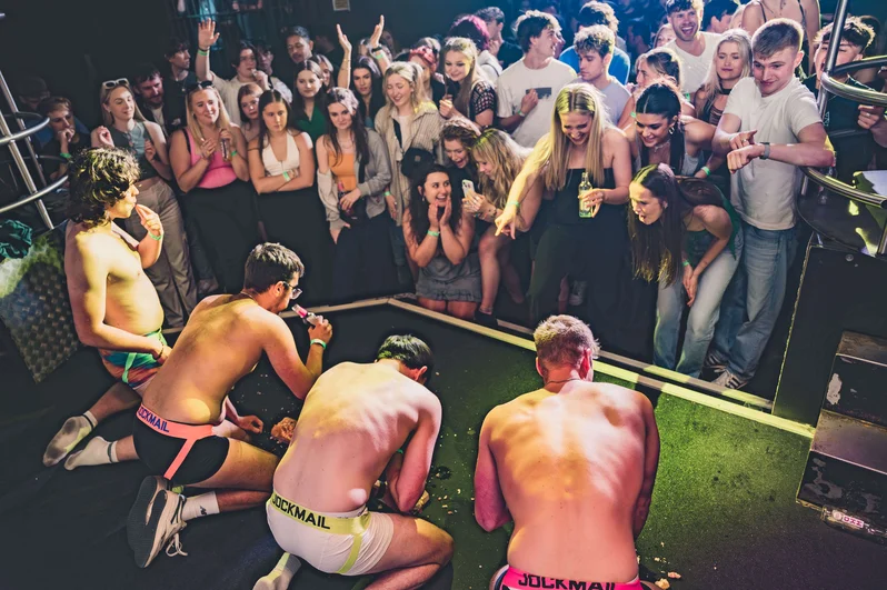 Young men on their knees on stage at OMG Bristol Club