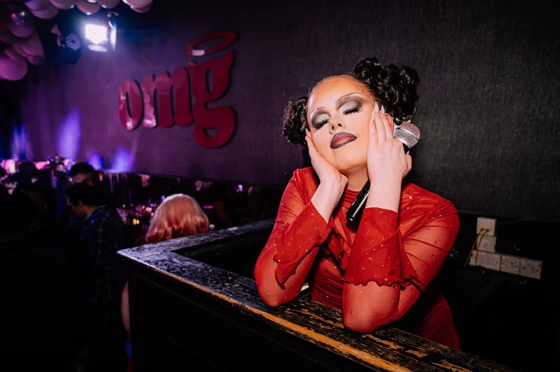 A drag queen holding a mic at OMG Liverpool