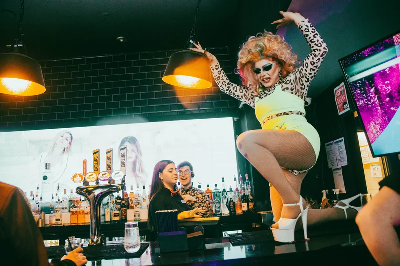 A drag queen dances on the bar at OMG Liverpool