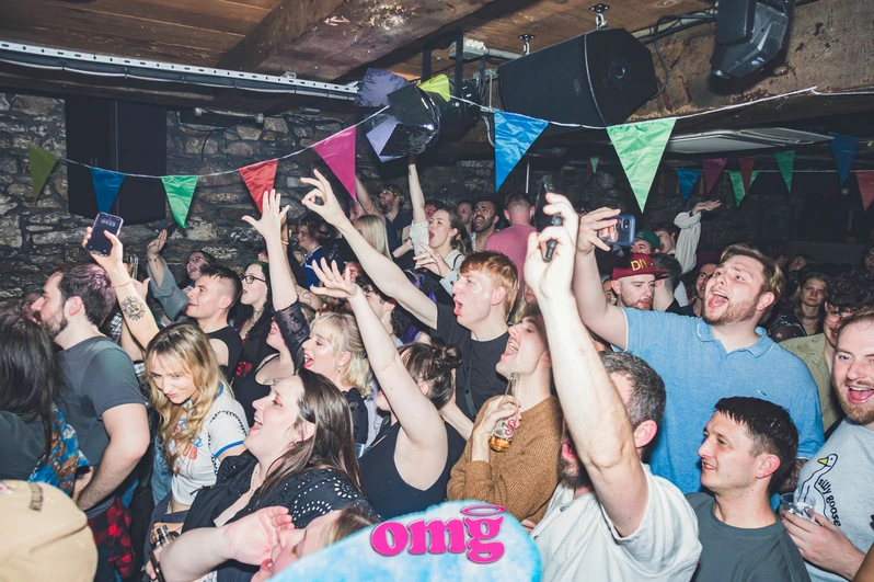 Clubbers raise their hands on the dancefloor at OMG Plymouth