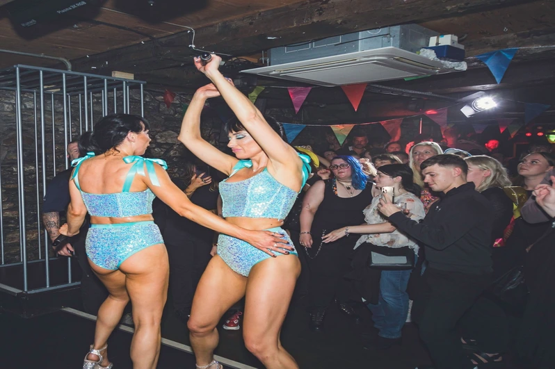 Two ladies dancing on the stage at OMG Plymouth